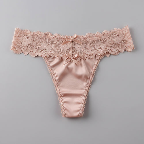 Pink lace thong on a gray fur surface