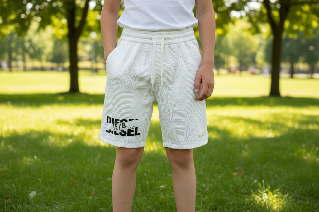 White textured shorts with 'DIESEL' branding on a hanger against a gray background.